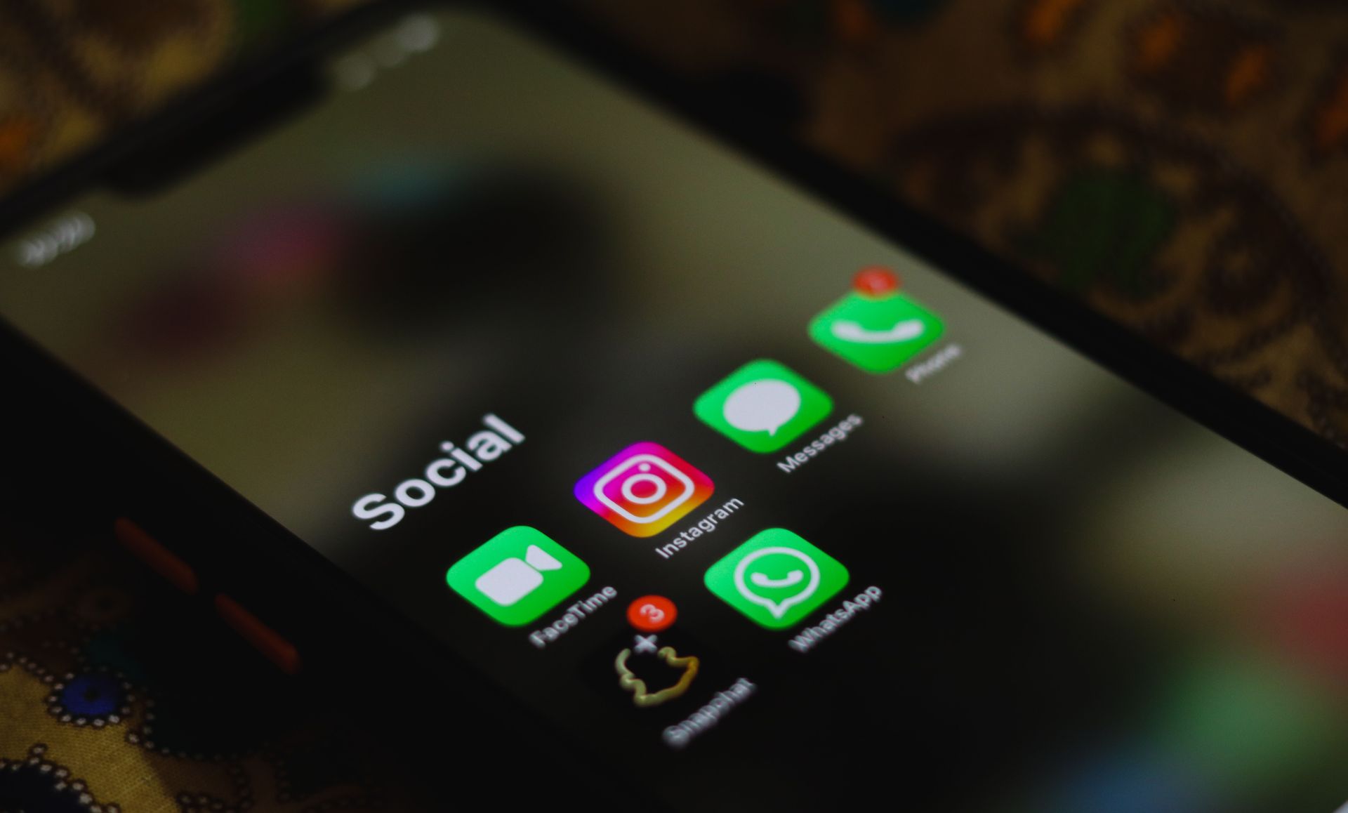 Smartphone home screen showing social media app icons on a dark background
