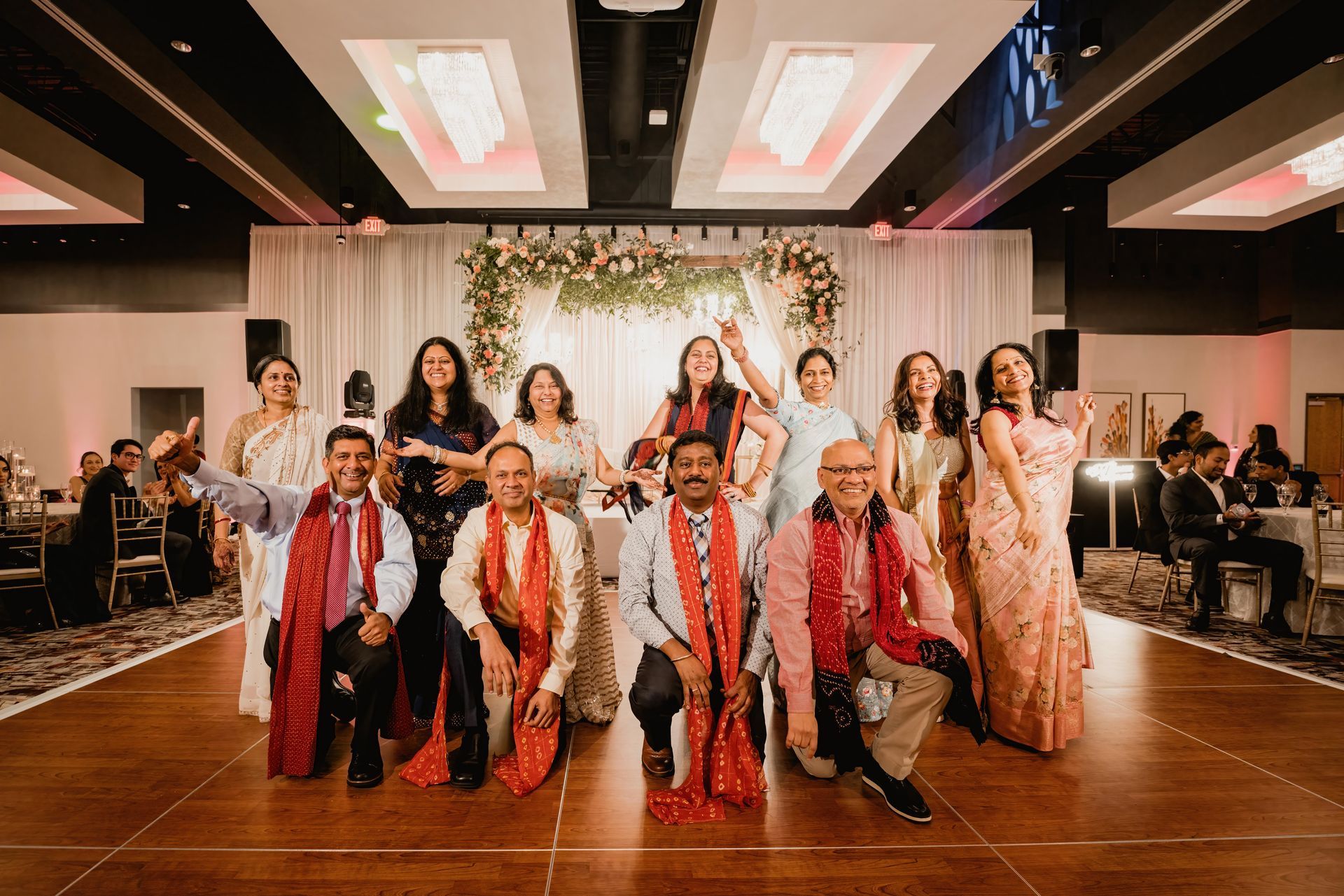 A group of people are posing for a picture on a dance floor.