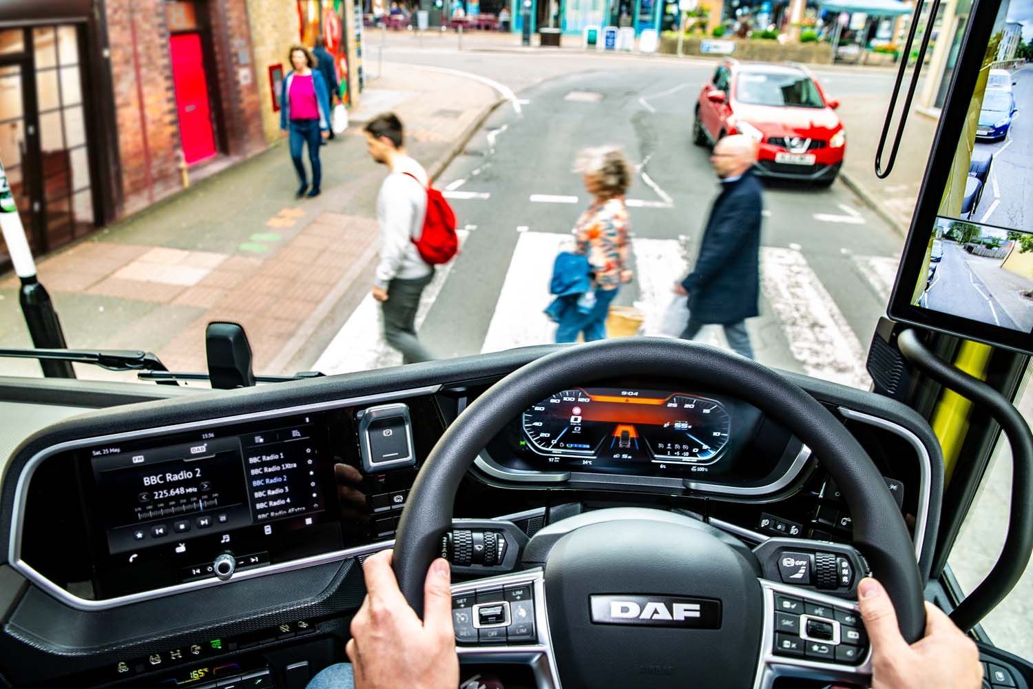 HGV photography of driver’s view from a bus cab approaching pedestrians at a city crosswalk