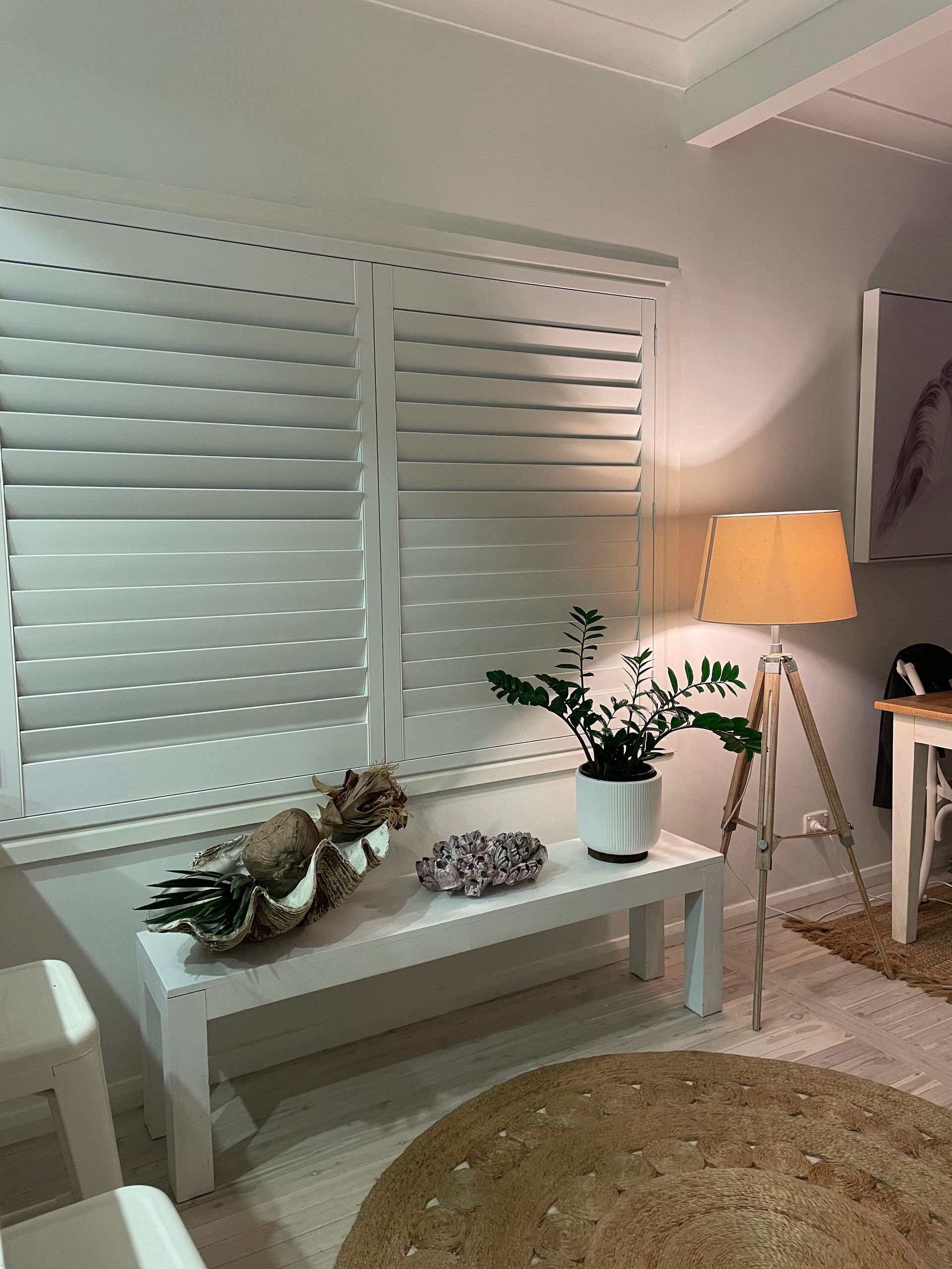 A Close up Of a Window with Wooden Blinds on It — Bay Blinds & Doors in Bateau Bay, NSW