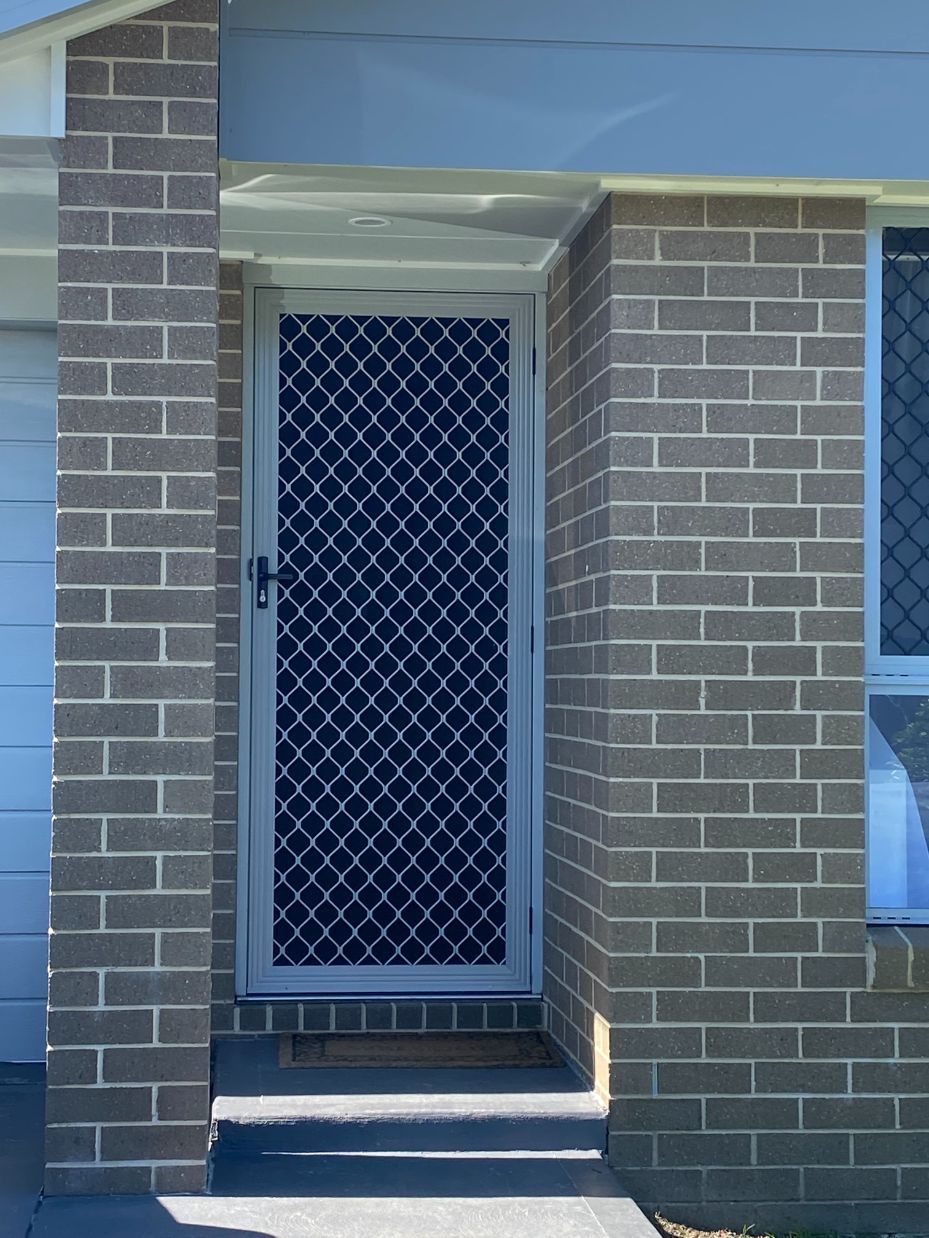 A House with A Swimming Pool in The Backyard — Bay Blinds & Doors in Berkeley Vale, NSW