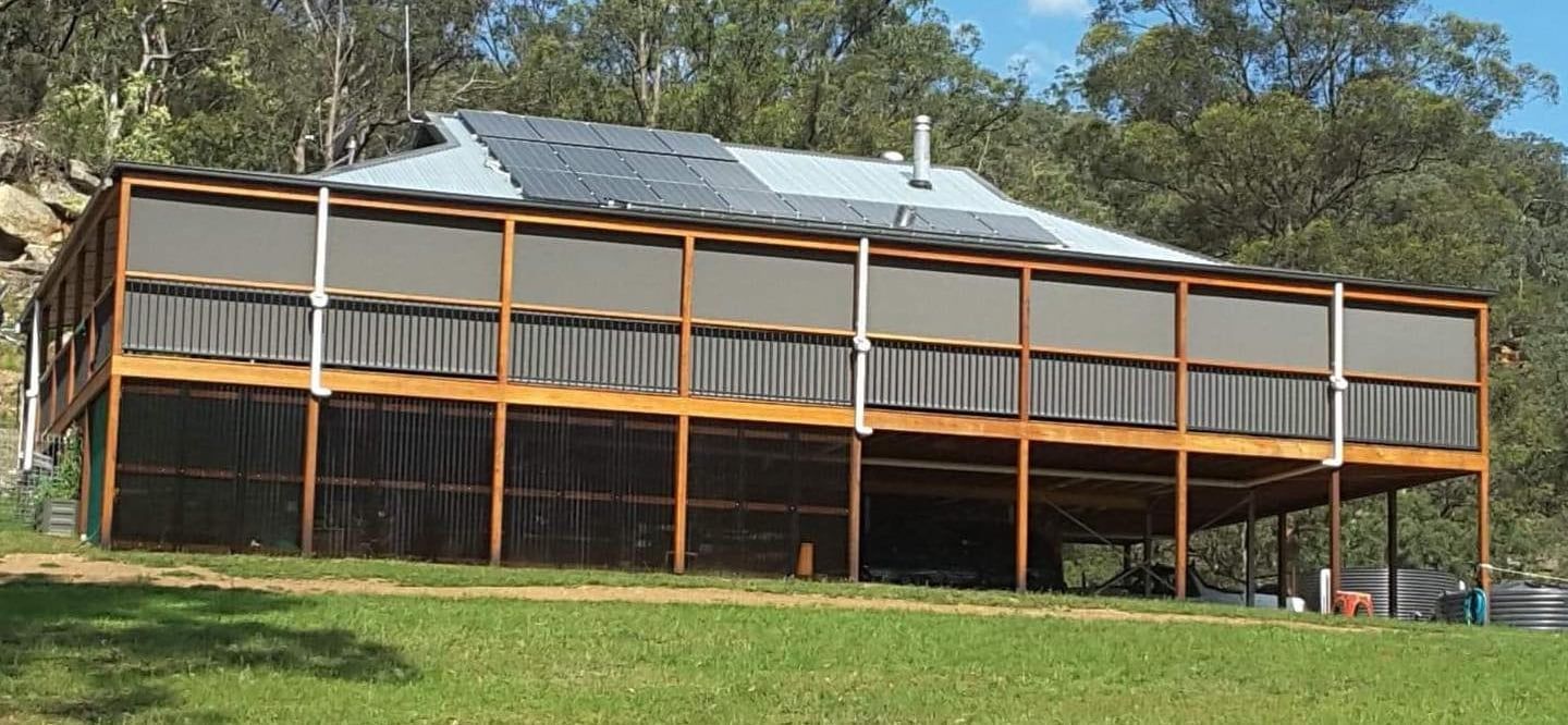 A House with A Porch with Blinds on It — Bay Blinds & Doors in Erina, NSW