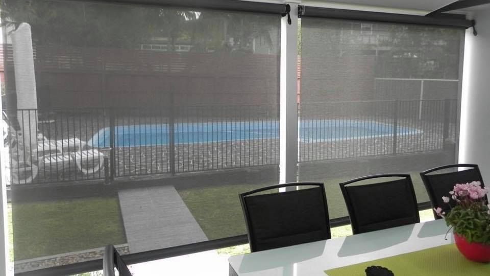 A Living Room with a Couch and Two Windows with Blind -  Bay Blinds & Doors in Lake Charmhaven, NSW
