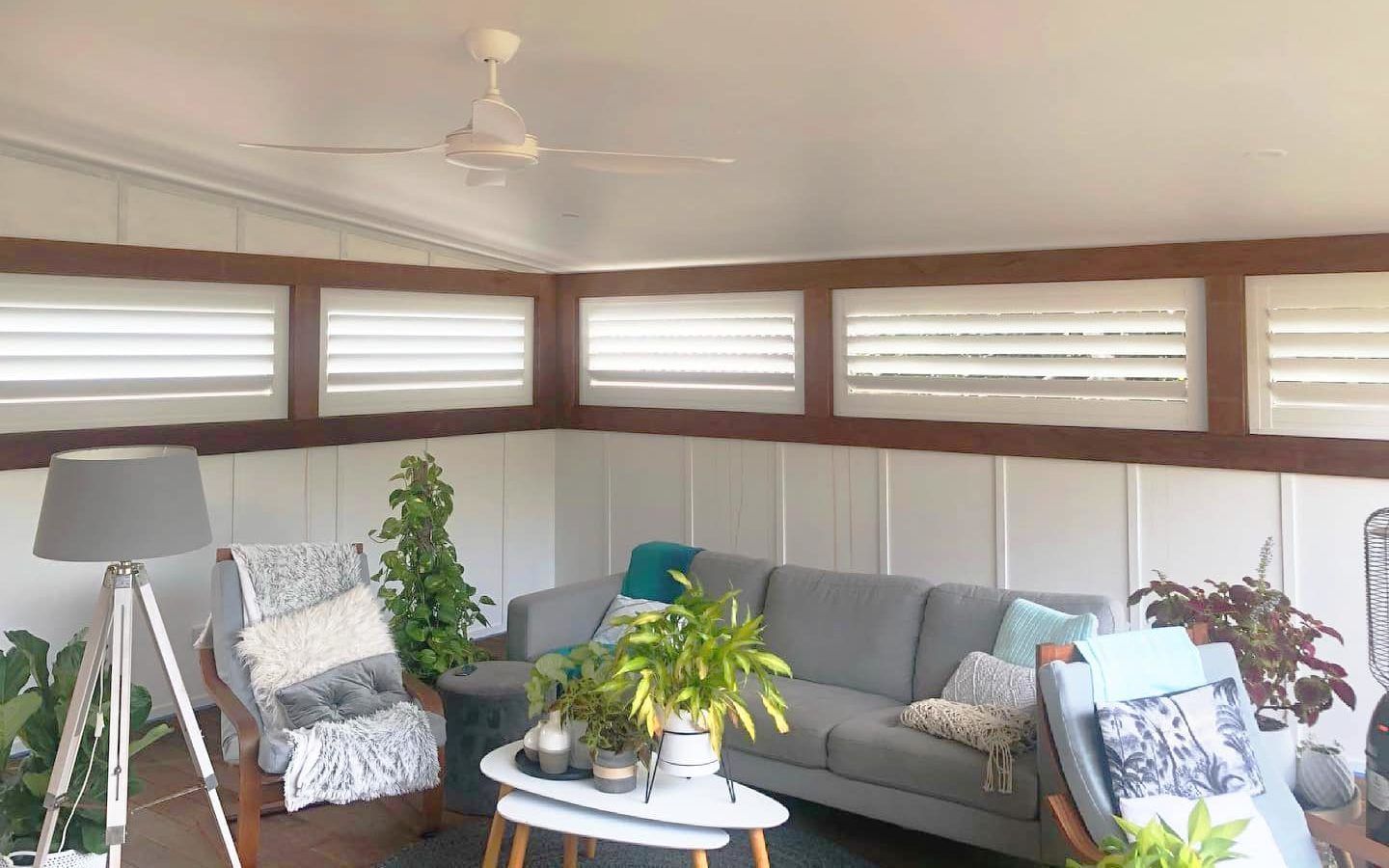 A Cat Is Standing In Front Of A Sliding Glass Door With Blinds — Bay Blinds & Doors in Bateau Bay, NSW