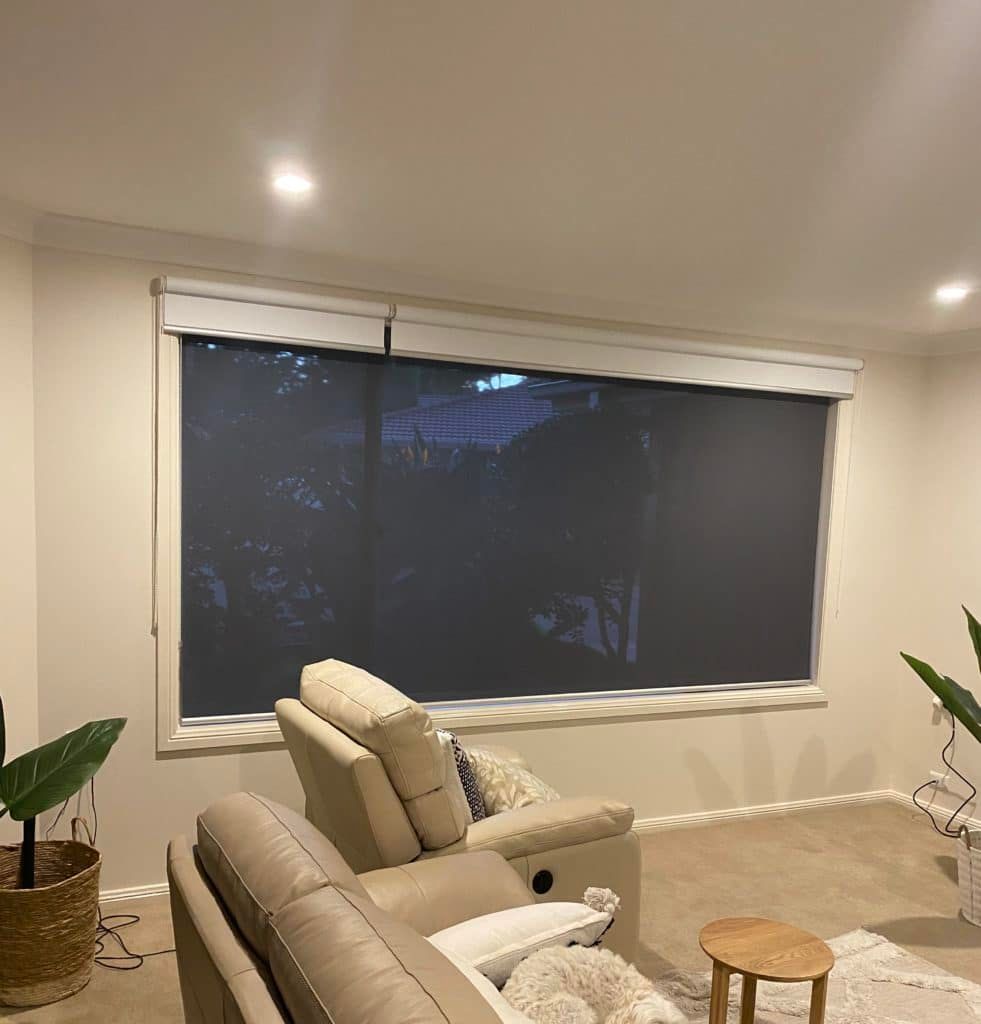 A Living Room with A Couch , Chair and A Large Window — Bay Blinds & Doors in Bateau Bay, NSW