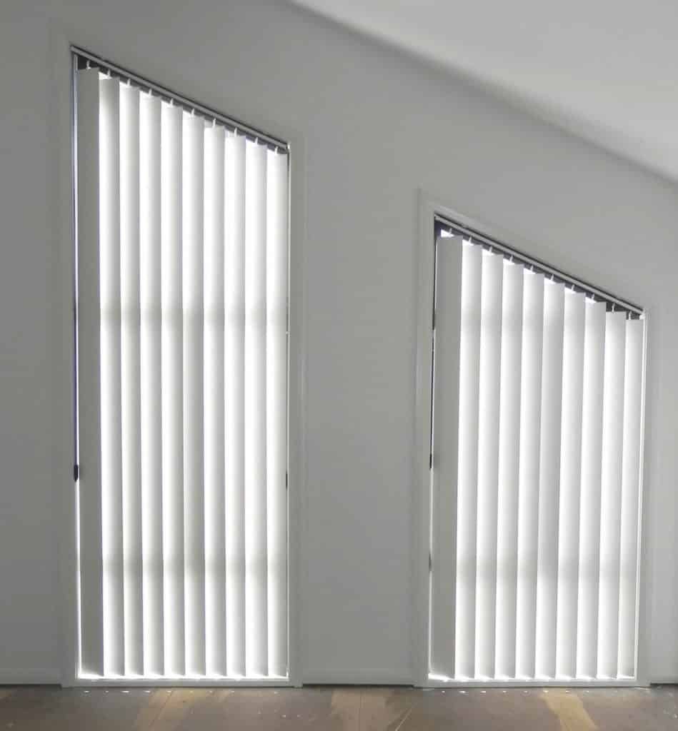 A Close up Of Vertical Blinds on A Window — Bay Blinds & Doors in Bateau Bay, NSW