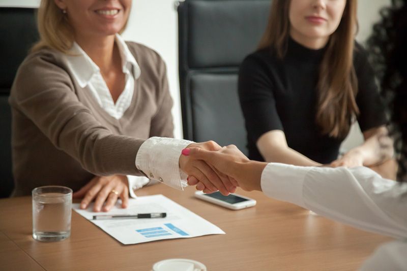 A Woman is Shaking Hands With Another Woman — Beerwah Co-Op in Beerwah, QLD