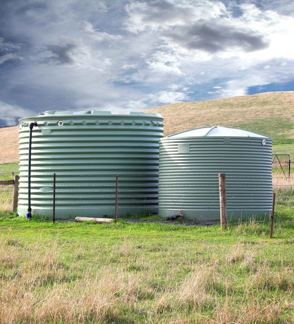 Two Water Tanks Are Sitting in the Middle of a Grassy Field — Beerwah Co-Op in Beerwah, QLD