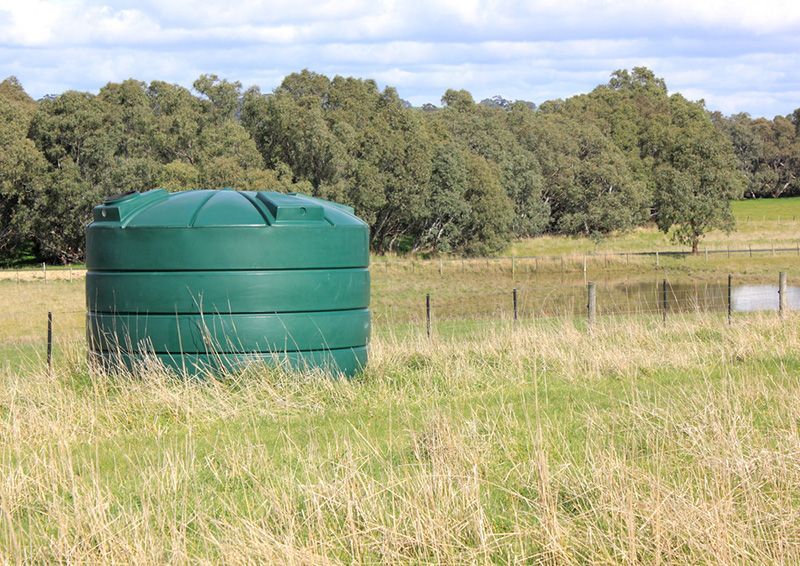 A Green Water Tank in the Middle of a Grassy Field — Beerwah Co-Op in Beerwah, QLD