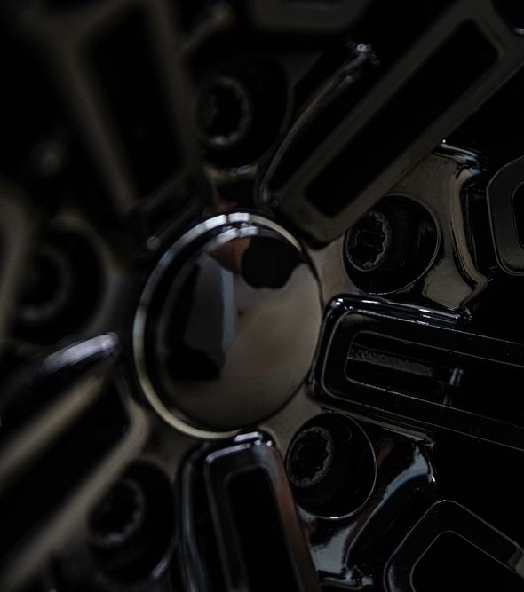 Close-up of a glossy black and chrome alloy wheel rim