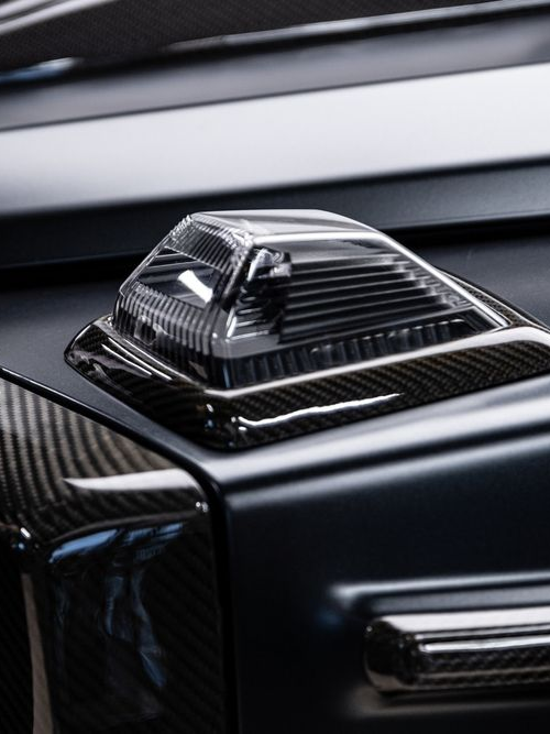 Glossy black car roof detail with a chrome shark-fin antenna