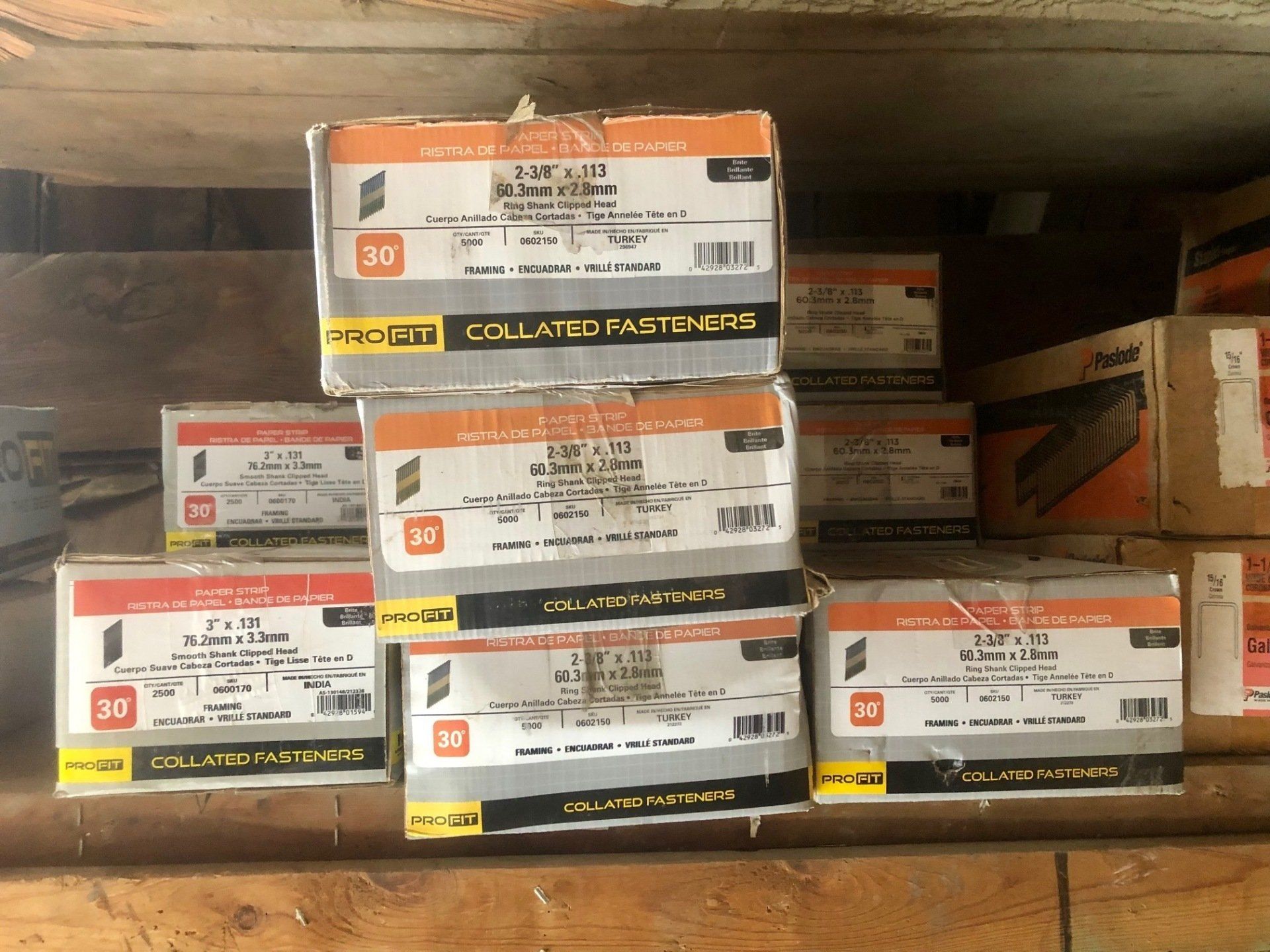 boxes of nails are stacked on top of each other.