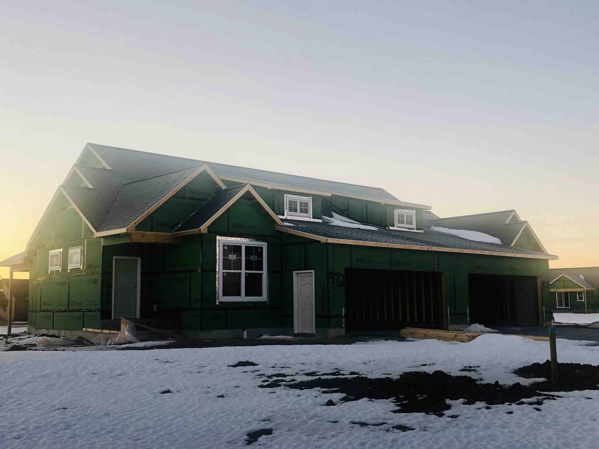 a green house is being built in the snow .