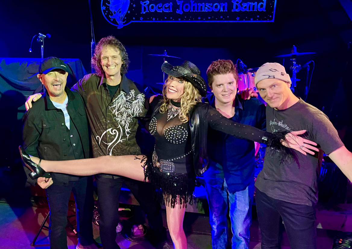 A group of people are posing for a picture on a stage.