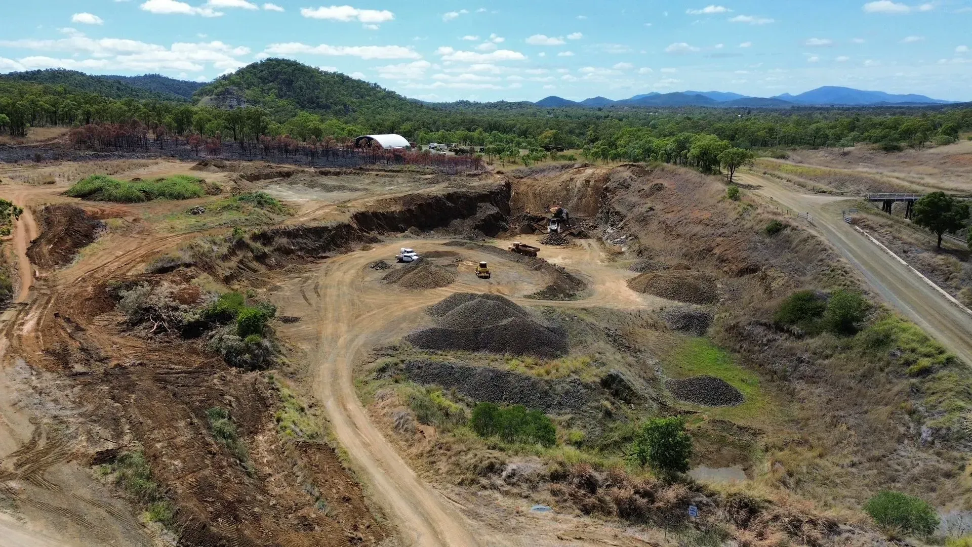 Aerial View of an Open-pit Mine in a Dry, Hilly Landscape — The Caves Quarry CQ in The Caves, QLD