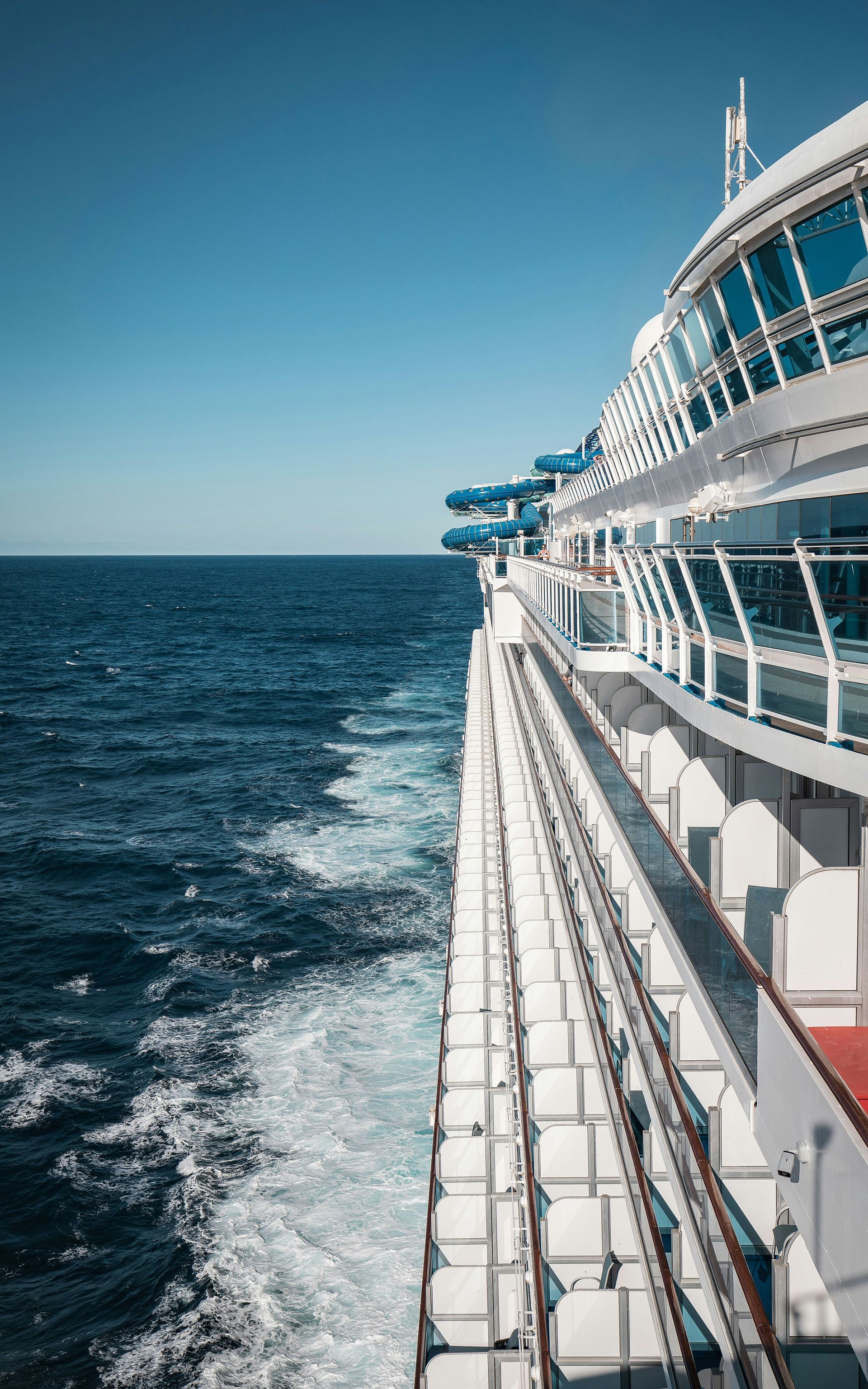 Luxury cruise ship at Greek port with scenic island backdrop