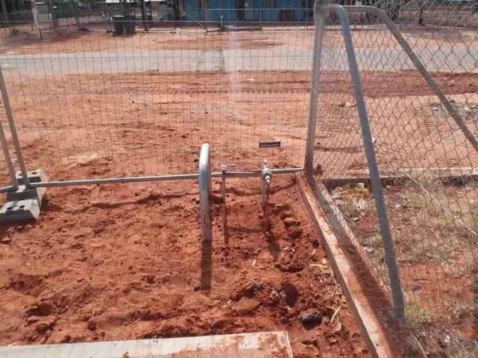 A Fence Is Sitting In The Middle Of A Dirt Field — Araluen Plumbing In Braitling, NT