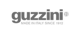 Logo Guzzini con la scritta “Made in Italy since 1912” in grigio su sfondo bianco.