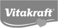 Logo Vitakraft in bianco su sfondo grigio con un elemento decorativo a forma di cuore.
