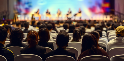 Seated audience before a stage for an event