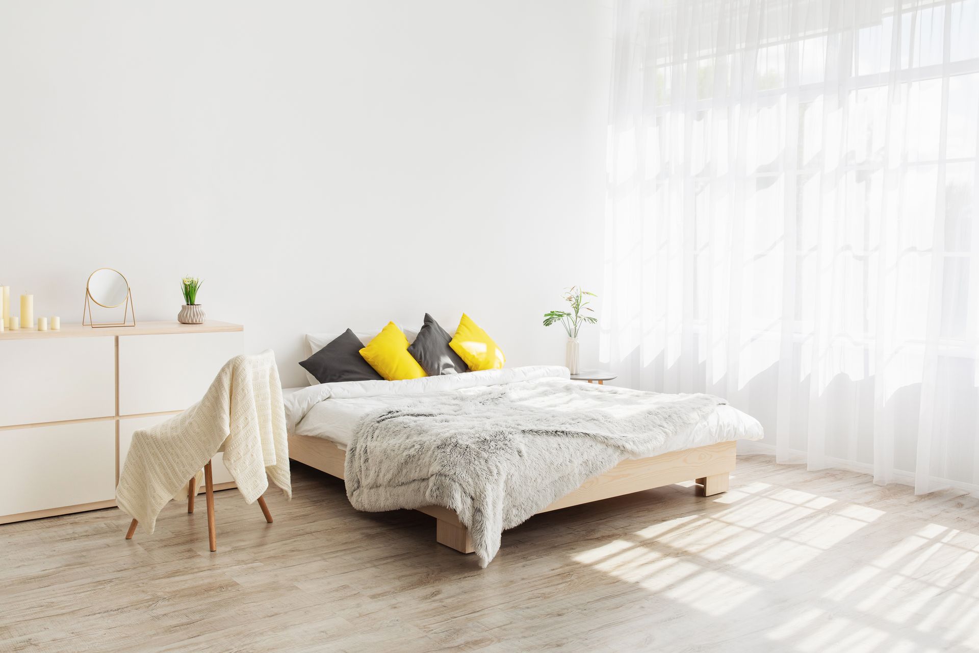A bedroom with a large bed and a window.