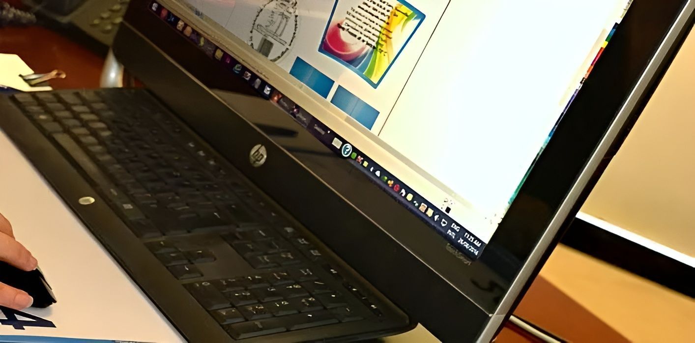 A person is typing on an HP laptop — Aldine Printers in Bungalow, QLD