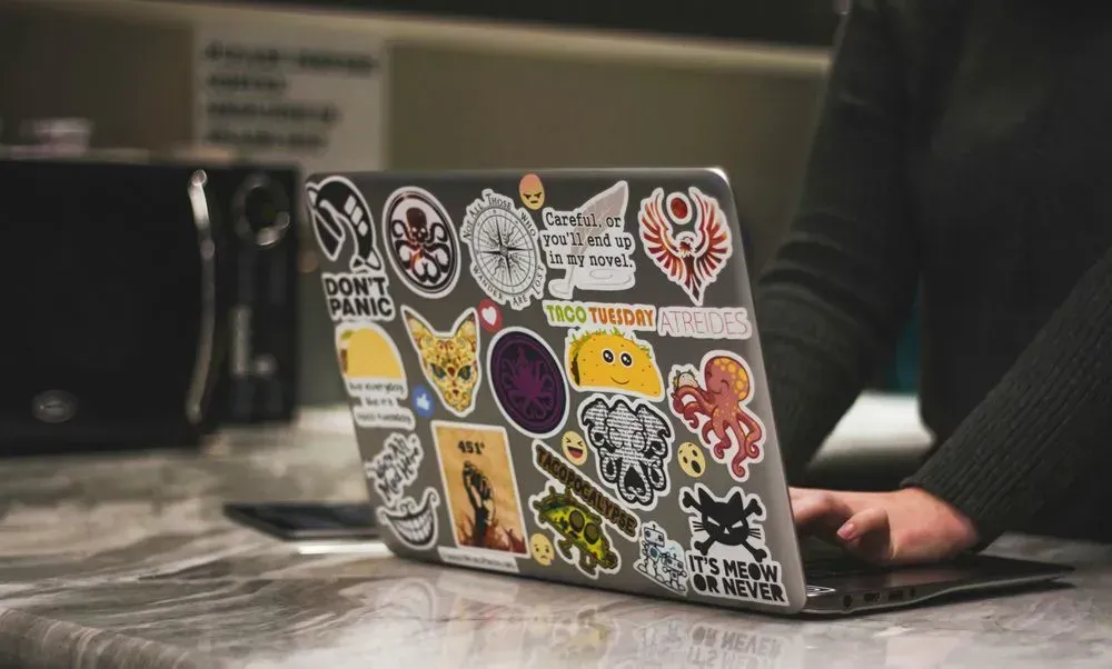 Collection Of Stickers On Laptop Computer — Aldine Printers in Bungalow, QLD
