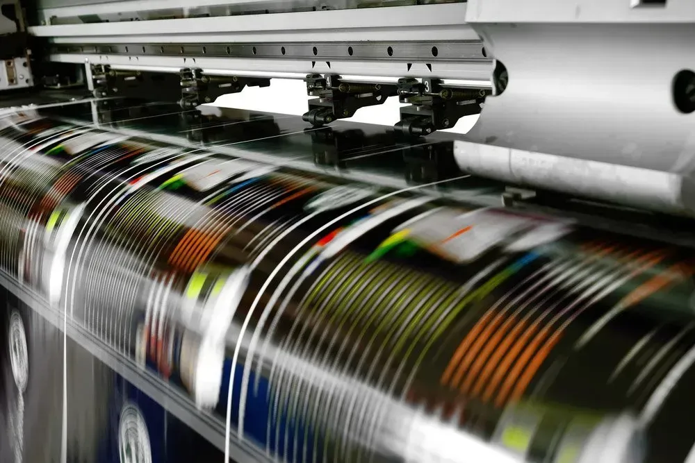 A Printing Machine is Printing a Large Sheet of Paper — Aldine Printers in Bungalow, QLD