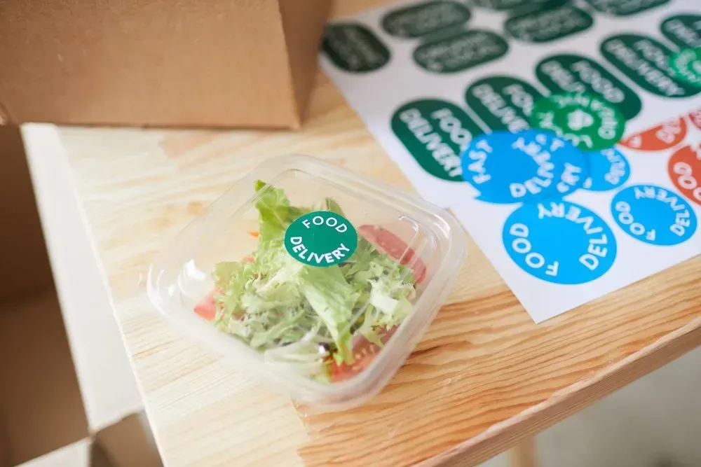 A Salad in a Plastic Container on a Wooden Table โ Aldine Printers in Bungalow, QLD