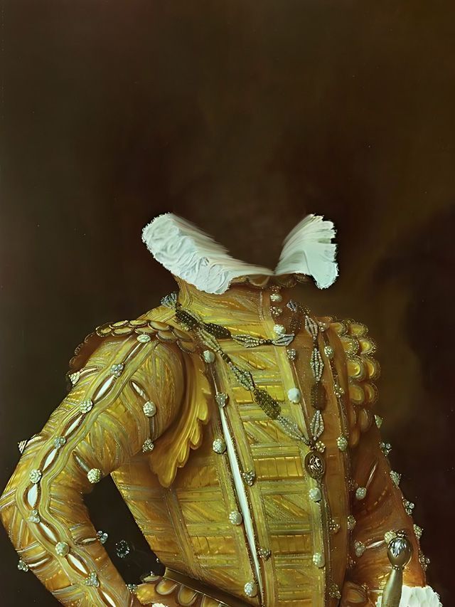 Gold embroidered jacket with a white ruffled collar.