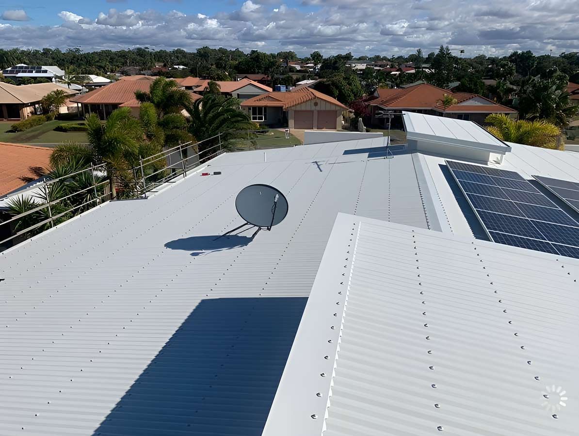 An Aerial View of a Roof With a Satellite Dish and Solar Panels — Ben McLennan Constructions in Grafton, NSW