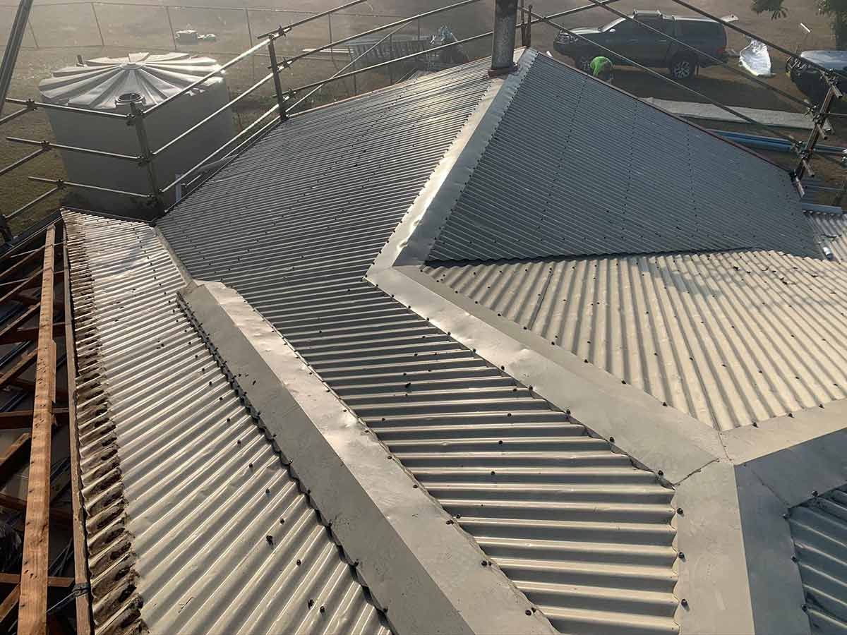 A close up of a metal roof with a staircase leading up to it — Ben McLennan Constructions in Coffs Harbour, NSW