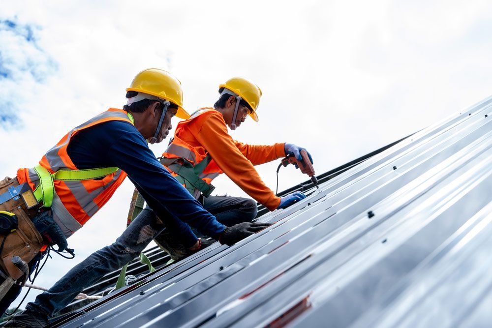 Two Construction Workers Are Working on the Roof of a Building — Ben McLennan Constructions in Grafton, NSW