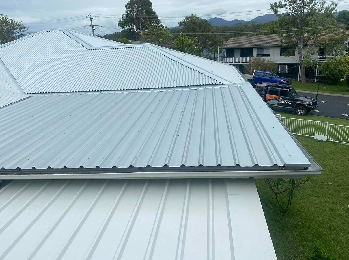 A White Roof With a Black Truck Parked on the Side of It — Ben McLennan Constructions in Grafton, NSW