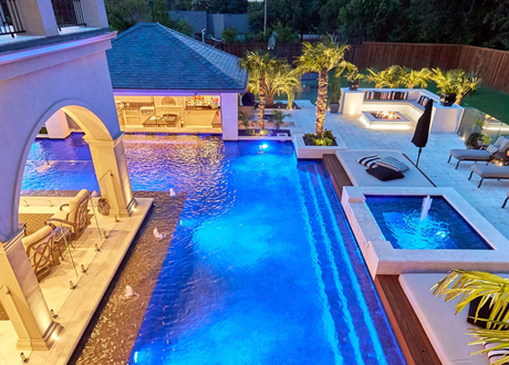 Custom pool and spa illuminated at dusk