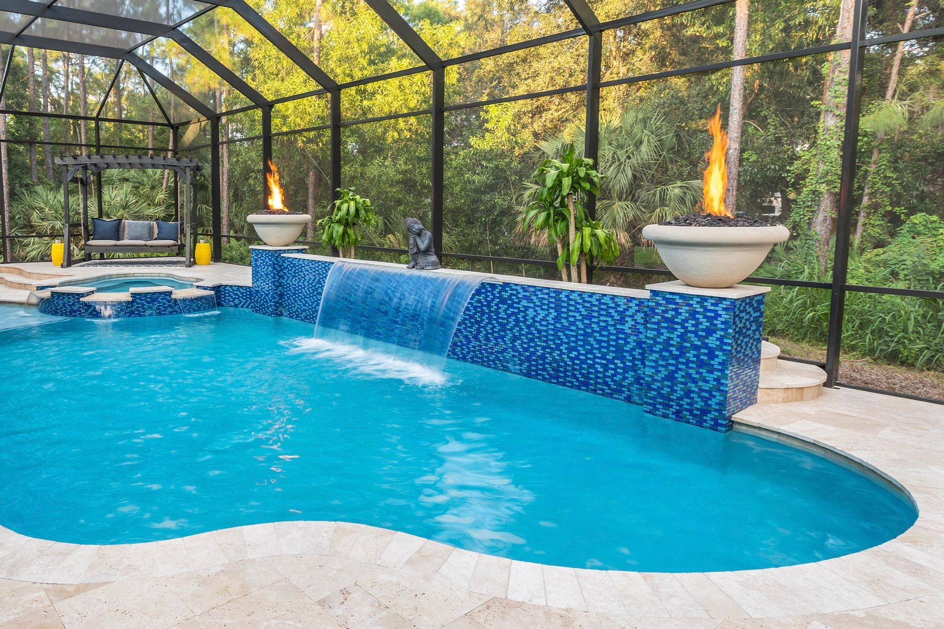 Natural stone waterfall cascading into a custom pool