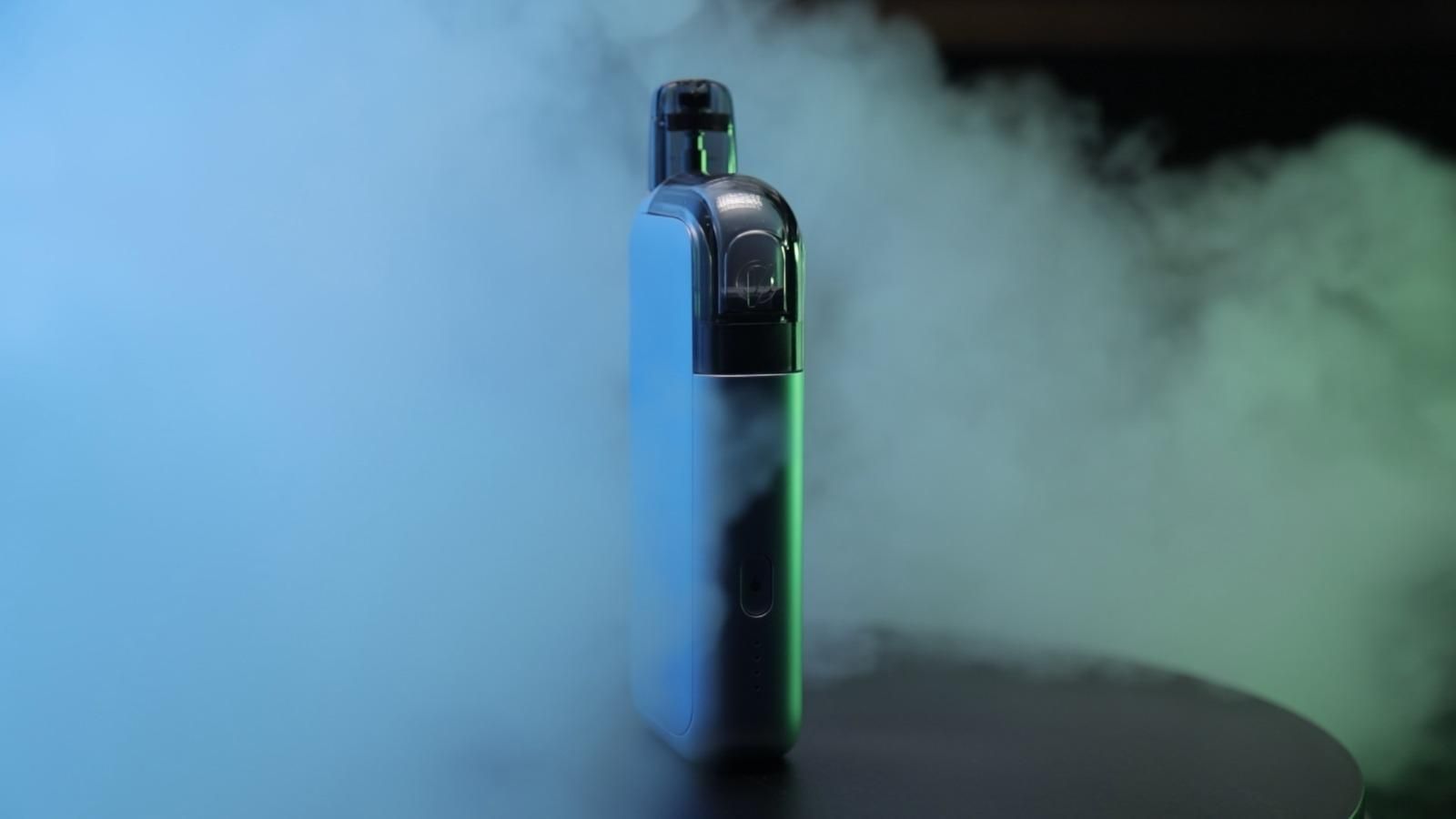 Una fila di bottiglie di e-liquid sono allineate su uno scaffale di legno.