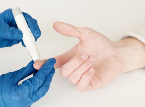 A person is being tested for diabetes by a doctor.