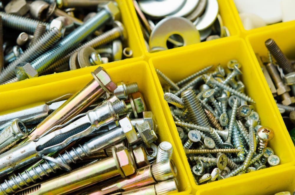 A Yellow Box Filled With Lots Of Different Types Of Screws And Bolts — All Trades Equipment In Lismore, NSW