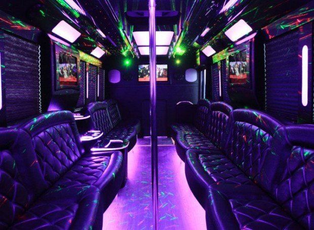 The inside of a limousine with purple and green lights.