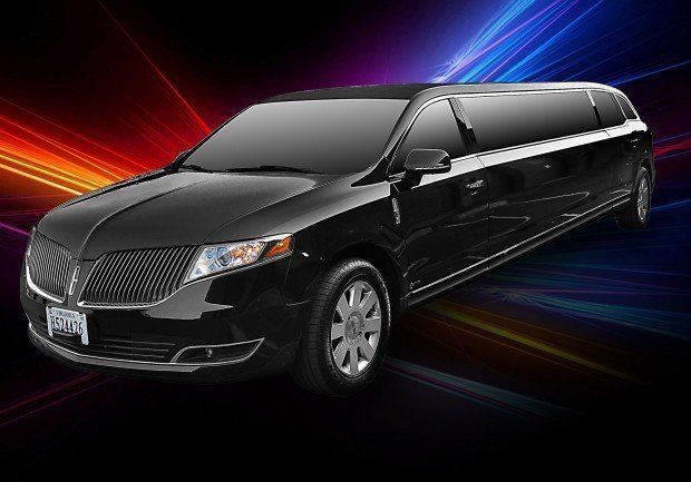A black limousine is parked in front of a colorful background.
