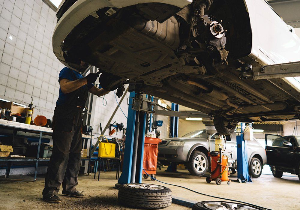 Car On Lift Changing Engine Oil — Hagerstown, MD — Guaranteed Truck & Auto Repair