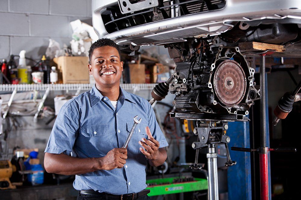 Mechanic Fixing The Car Transmission — Hagerstown, MD — Guaranteed Truck & Auto Repair Mechanic Fixing The Car Transmission — Hagerstown, MD — Guaranteed Truck & Auto Repair