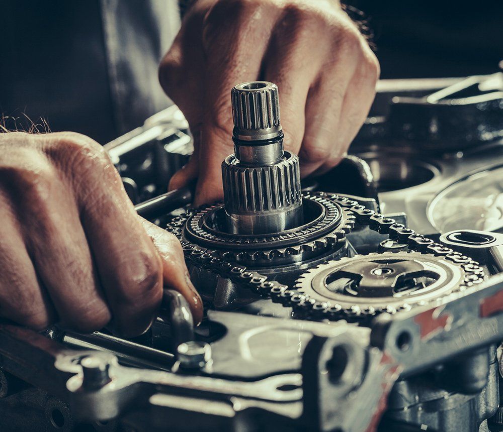 Person Fixing The Gearbox — Hagerstown, MD — Guaranteed Truck & Auto Repair Person Fixing The Gearbox — Hagerstown, MD — Guaranteed Truck & Auto Repair