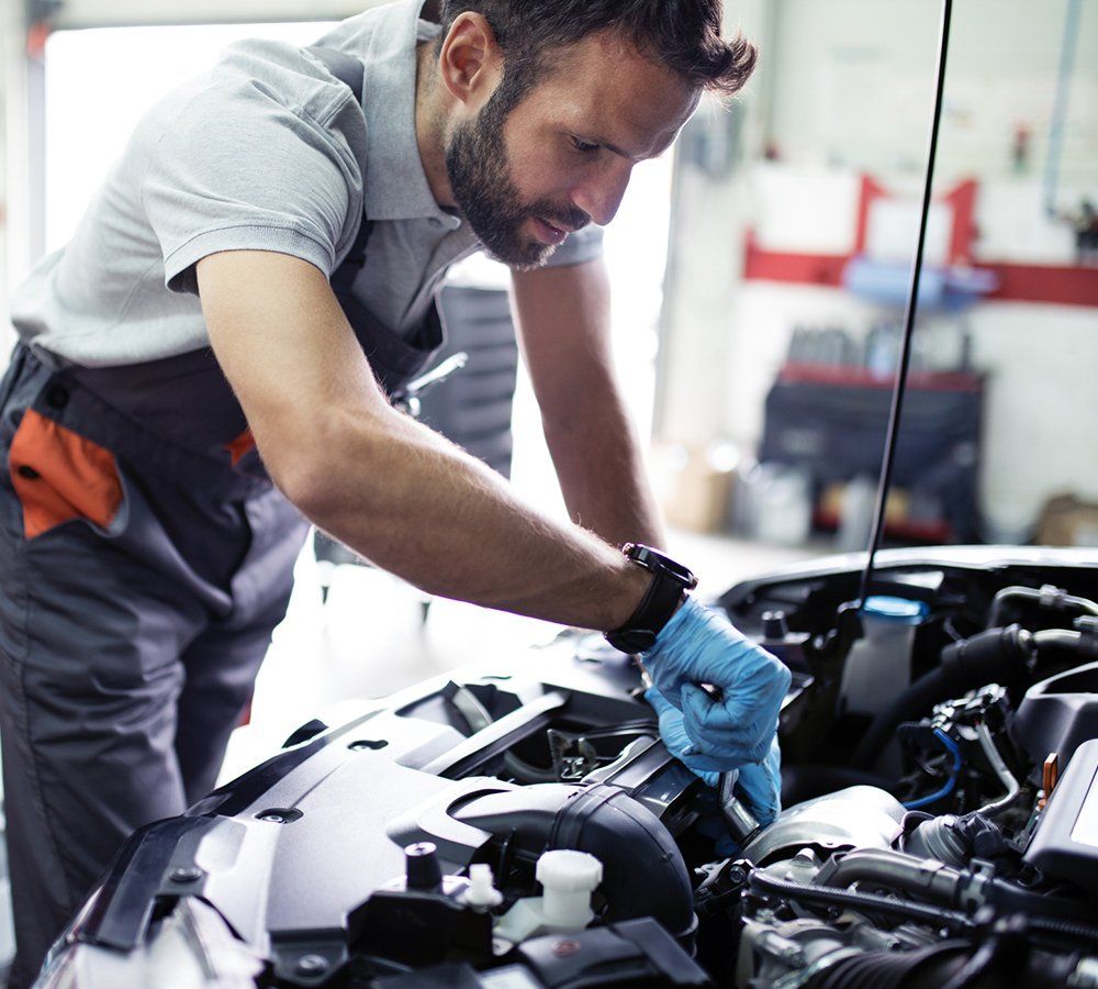Expert Checking Car Engine — Hagerstown, MD — Guaranteed Truck & Auto Repair Expert Checking Car Engine — Hagerstown, MD — Guaranteed Truck & Auto Repair