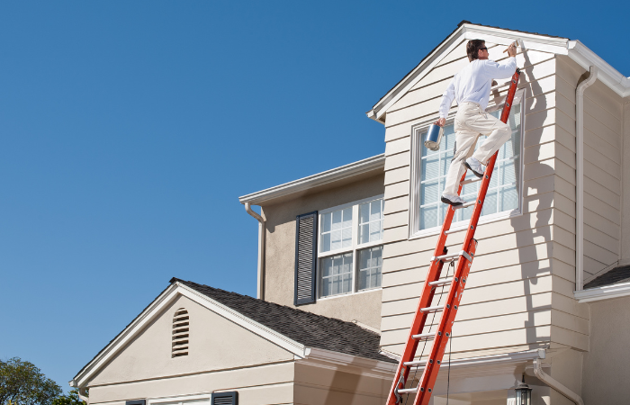 man painting house exterior on long island ny