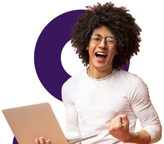 A man with an afro is holding a laptop and celebrating.