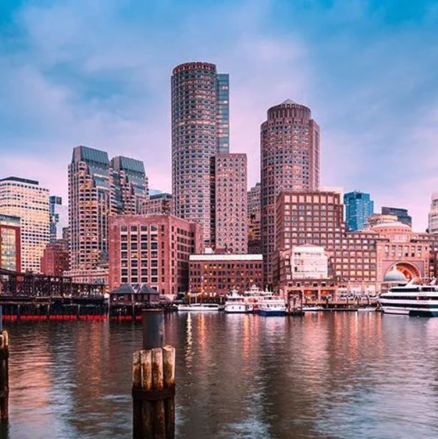 A city skyline with a body of water in the foreground