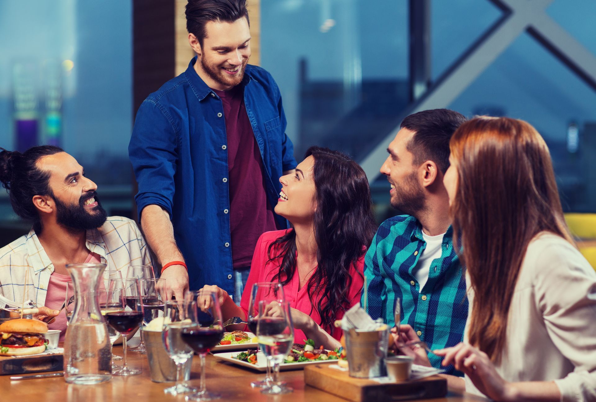 friends dining and drinking wine at restaurant