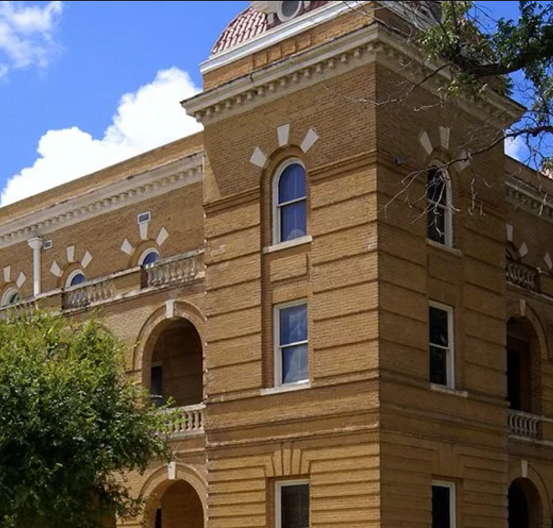 A large brick building with arched windows and balconies